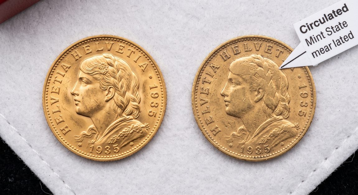 Two identical gold coins side by side showing different grades and condition