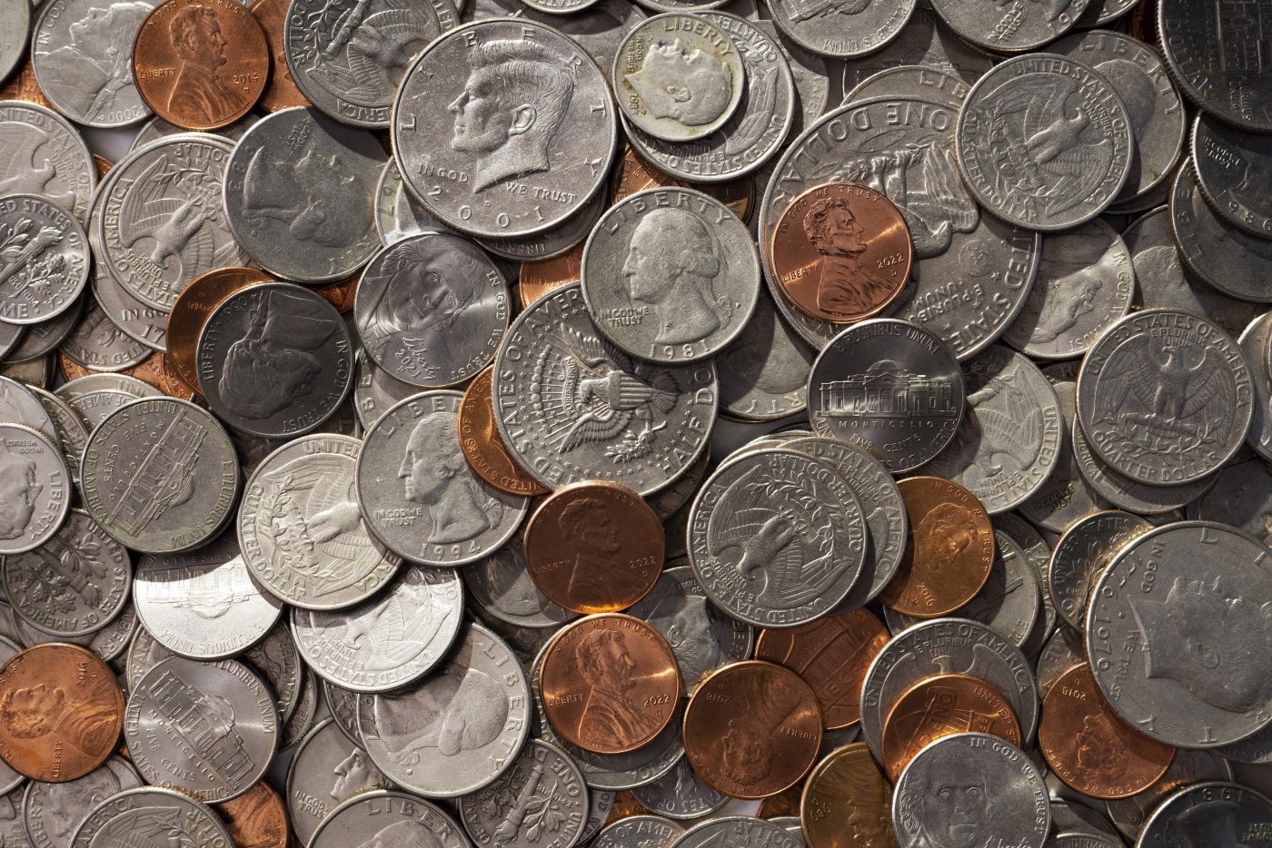A large pile of scattered U.S. coins