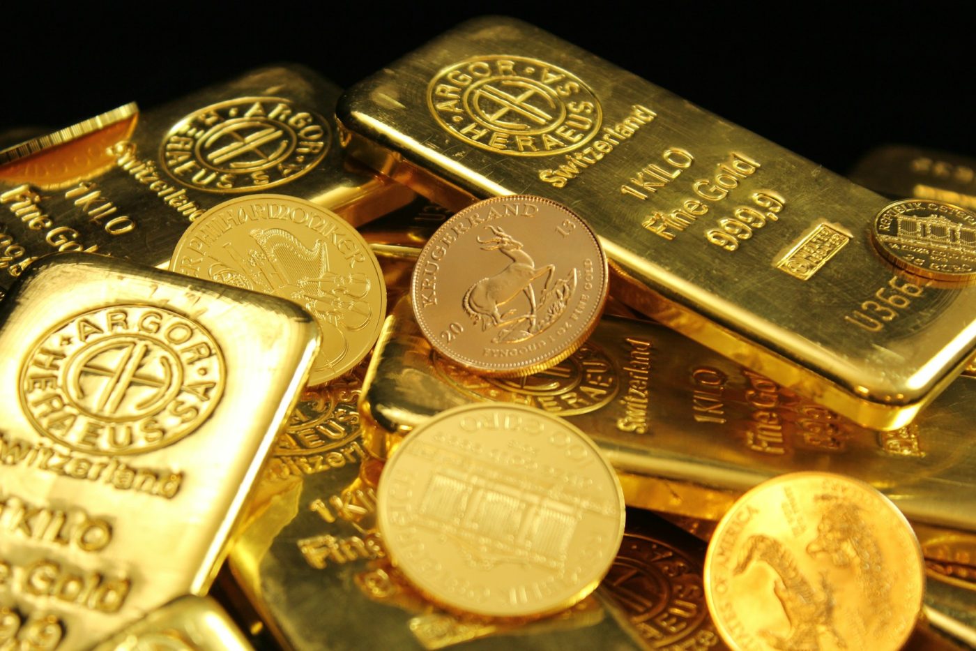 Gold bars and gold coins piled together