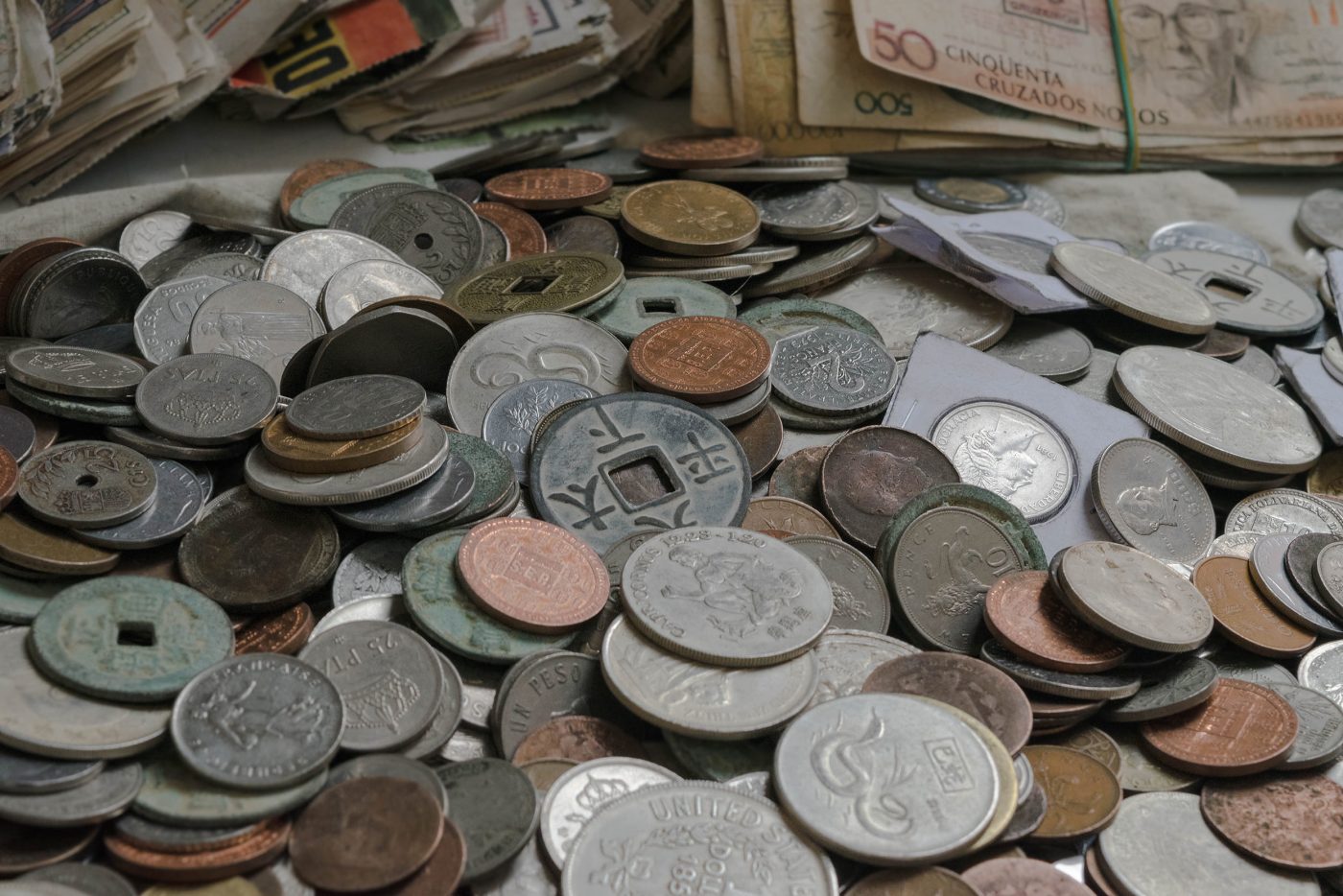 A pile of collectible world coins and paper currency